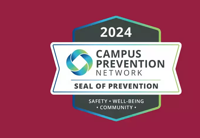 Badge with "2024 Campus Prevention Network Seal of Prevention" written inside. The badge features a multicolored circular logo. Below the text, it reads: "Safety • Well-being • Community" on a maroon background.